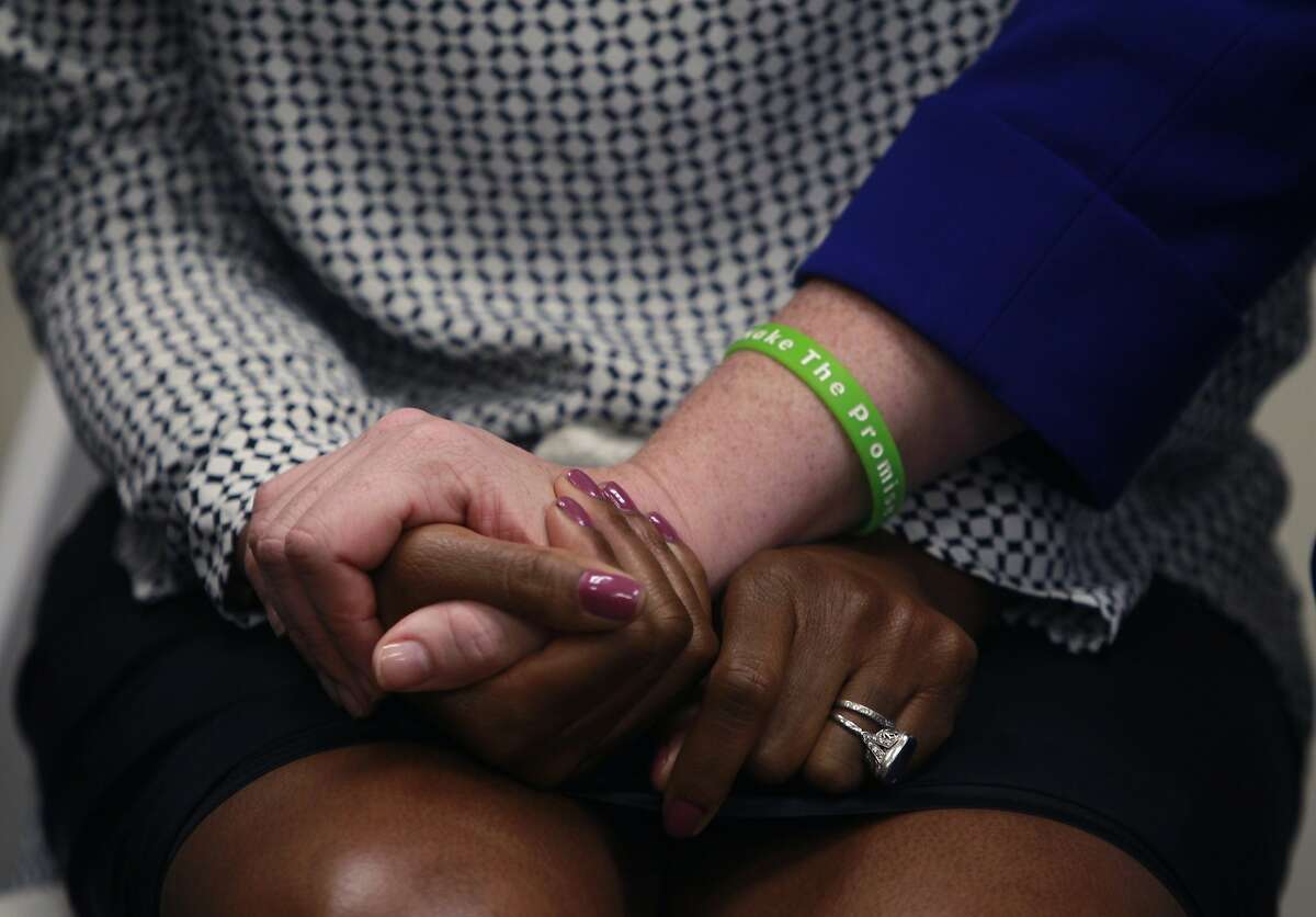 Dr. Nadine Burke Harris, founder and CEO of the Center for Youth Wellness, joins hands with Suzy Loftus, the center's COO, at the opening of the Bayview Child Health Center in San Francisco, Calif. on Wednesday, Feb. 26, 2014. The facility combines the services of a health clinic, wellness center and child abuse prevention center under one roof.