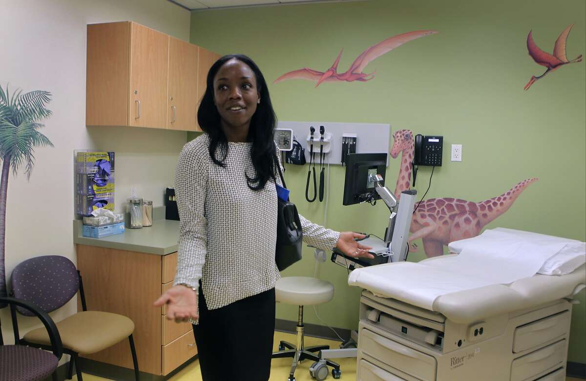 Dr. Nadine Burke Harris, founder and CEO of the Center for Youth Wellness, views a dinosaur-theme exam room at the opening of the Bayview Child Health Center in San Francisco, Calif. on Wednesday, Feb. 26, 2014. The facility combines the services of a health clinic, wellness center and child abuse prevention center under one roof.