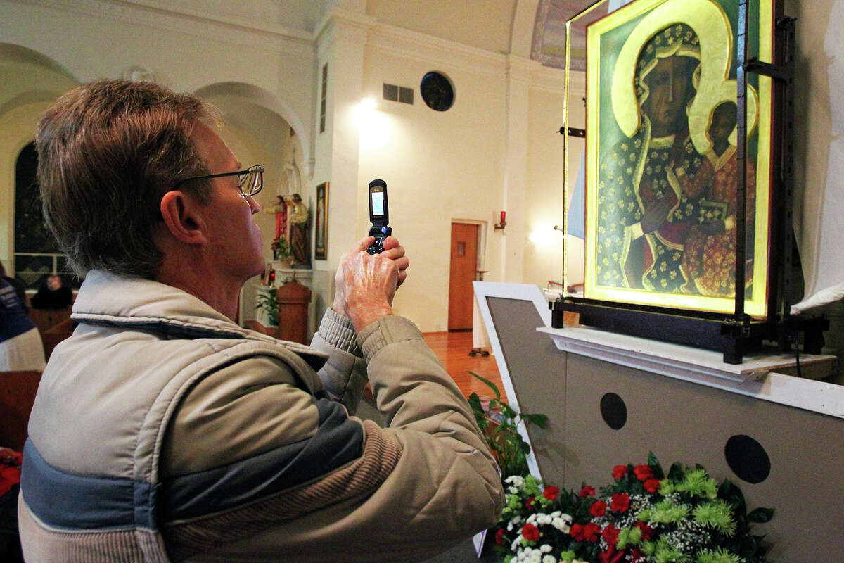 Glen Jones pictures the icon, Our Lady of Czestochowa, as the "Polish Madanna" is displayed at Our Lady Of Sorrows Catholic Church on February 26, 2014. The icon travels around the world to promote the culture of life and family.