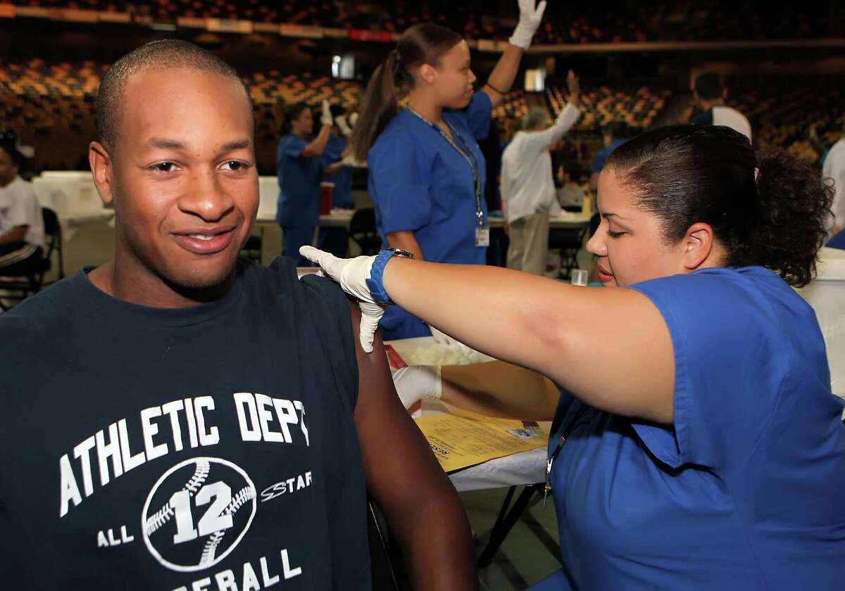 University of Central Florida (UCF) baseball player Chris Duffy and other UCF athletes got protected against the seasonal flu at Centra Care's mass vaccination event at the UCF Arena to set an example to the rest of the student body and community about the importance of getting vaccinated against seasonal influenza. They hope to break the Guinness World Record for Most Vaccinations in a Day. (Left to Right: Chris Duffy, Brenda Douglas) www.gethealthyflorida.com. (PRNewsFoto/Get Healthy Florida, Alex Menendez)