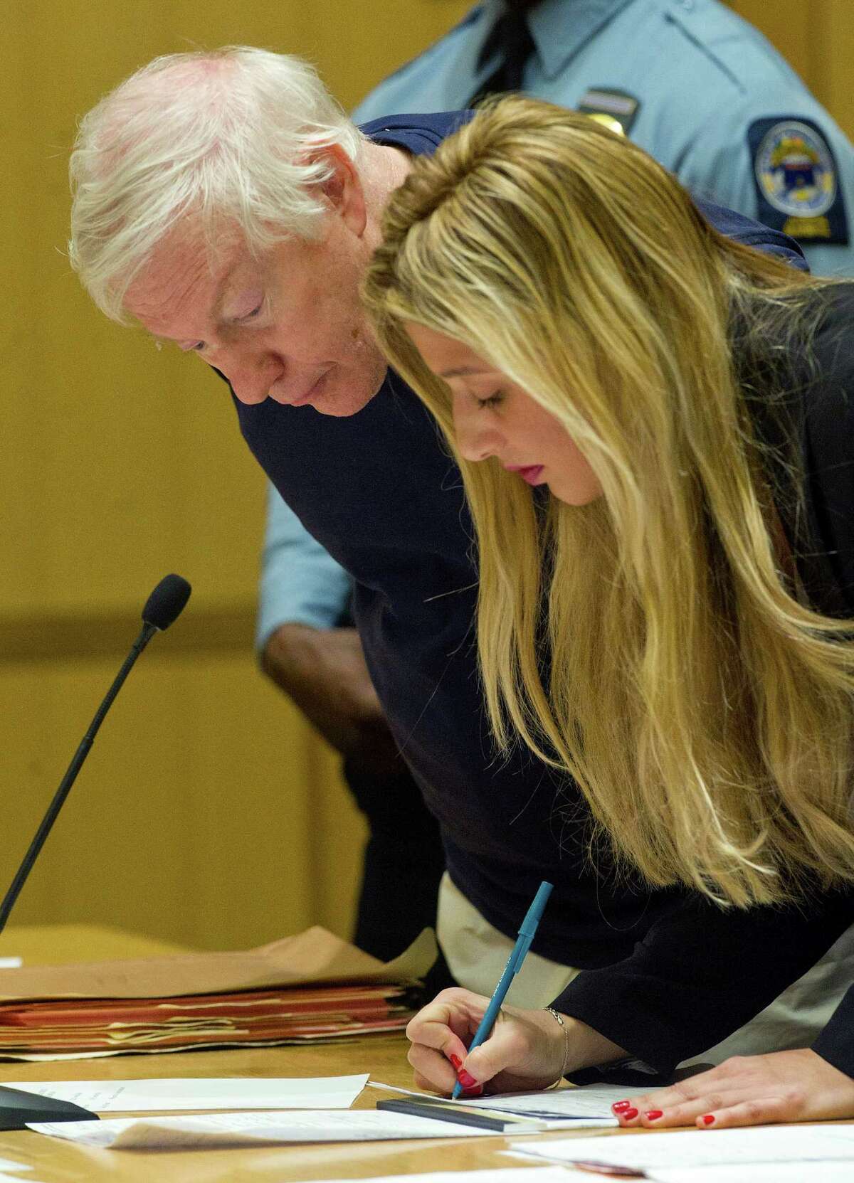 Michael Luecke stands with Antigone Curis, legal intern assisting the public defender, as he is arraigned at State Superior Court in Stamford, Conn., on Thursday, February 27, on charges stemming from Luecke allegedly masturbating in a hallway at Westhill High School where he was a substitute teacher.