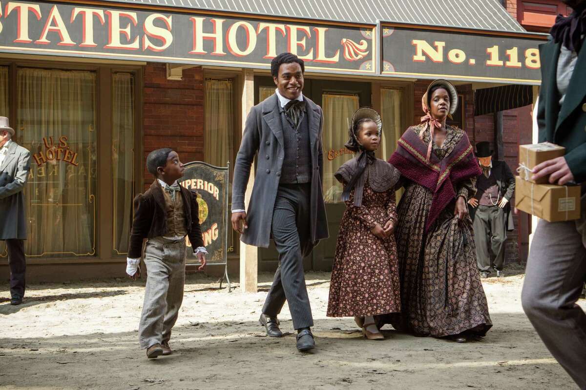 In the film "12 Years a Slave," Kelsey Scott, as Anne Northup, and children Quvenzhane Wallis, as Margaret, and Cameron Zeigler, as Alonzo, are seen boarding a carriage outside their home in Saratoga Springs with their father Solomon, portrayed by Chiwetal Ejiorfor, and outside the United States Hotel on Broadway, where Northup played the violin and Anne sometimes cooked, according to his memoir. (Courtesy of Fox Searchlight)