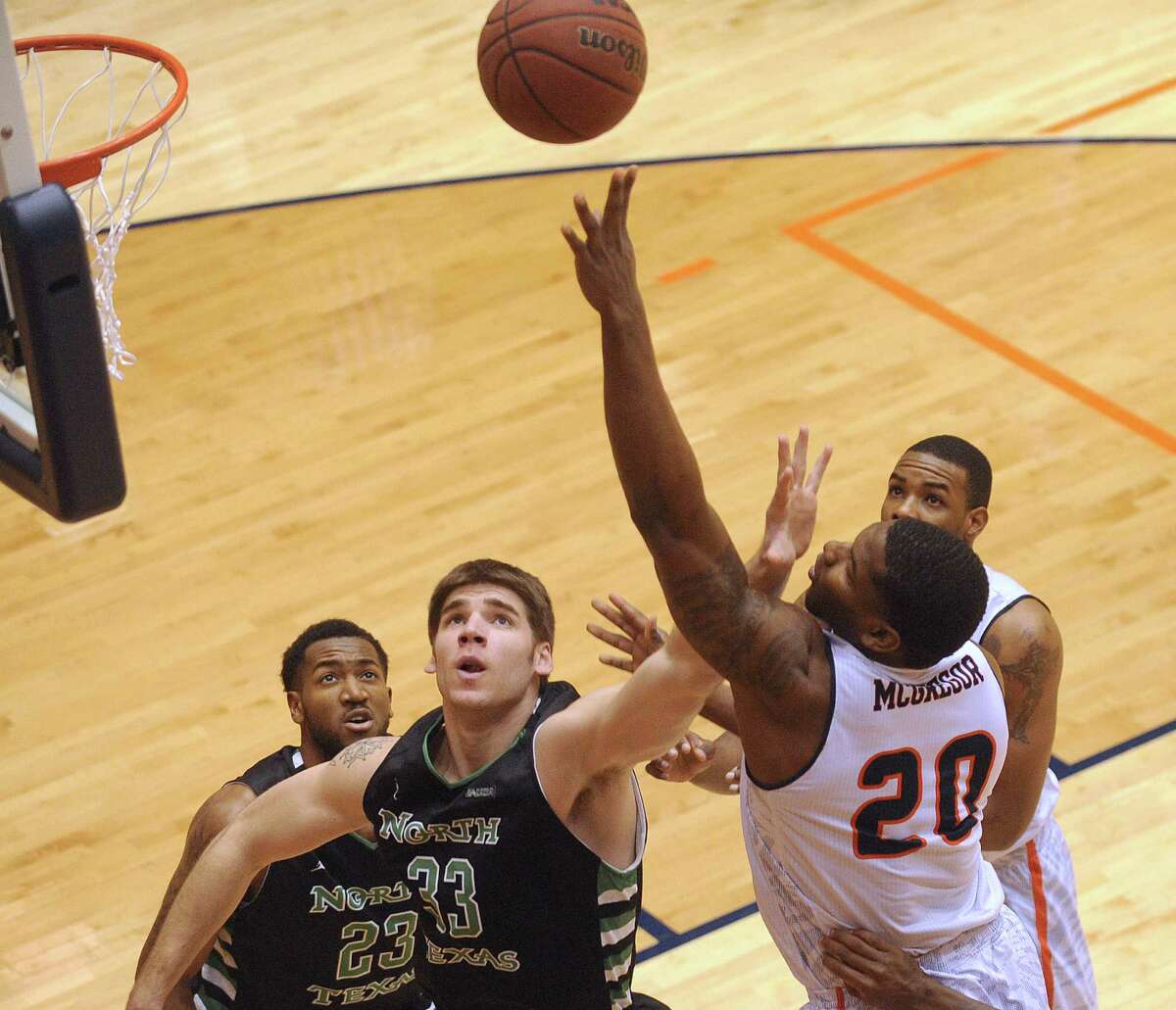 UTSA's Edrico McGregor shoots as Colin Voss of North Texas defends during college basketball action at the UTSA Convocation Center on Thursday, Feb. 27, 2014.