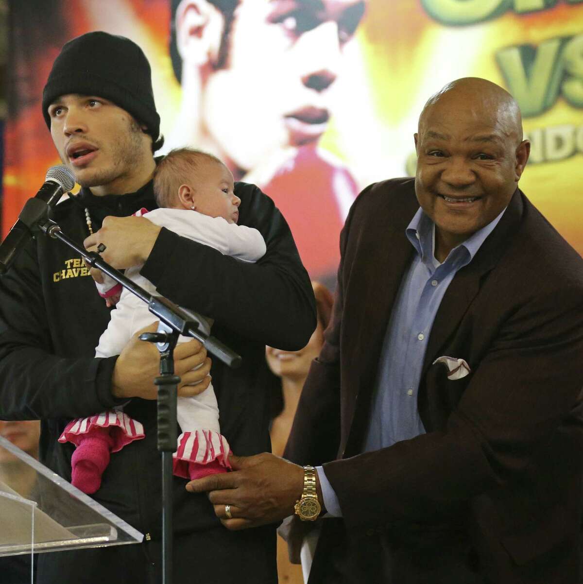 Julio Cesar Chavez Jr. (left), holding daughter Julia with George Foreman, faces Bryan Vera, but the bout between Vasyl Lomachenko and Orlando Salido is generating more buzz.
