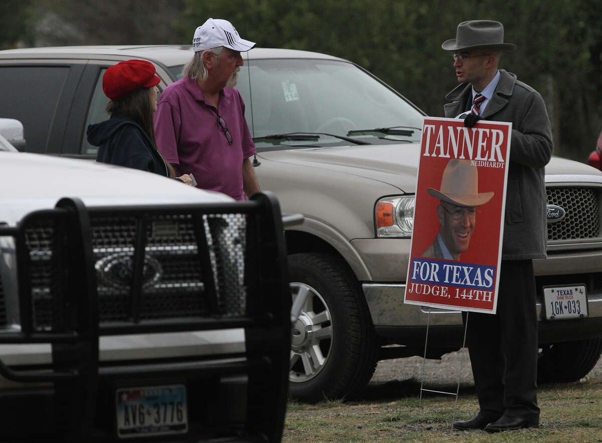 Judicial candidate Tanner Neidhardt (right) speaks Friday February 28, 2014 with people approaching the Brook Hollow Branch of the San Antonio Public Library on the last day of early voting for the March 4 primary.
