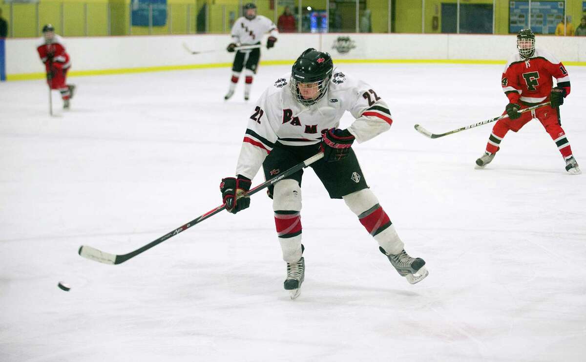 New Canaan's Patrick Hompe controls the puck during Friday's FCIAC quarterfinals against Fairfield at Terry Conners Rink in Stamford, Conn., on February 28, 2014.