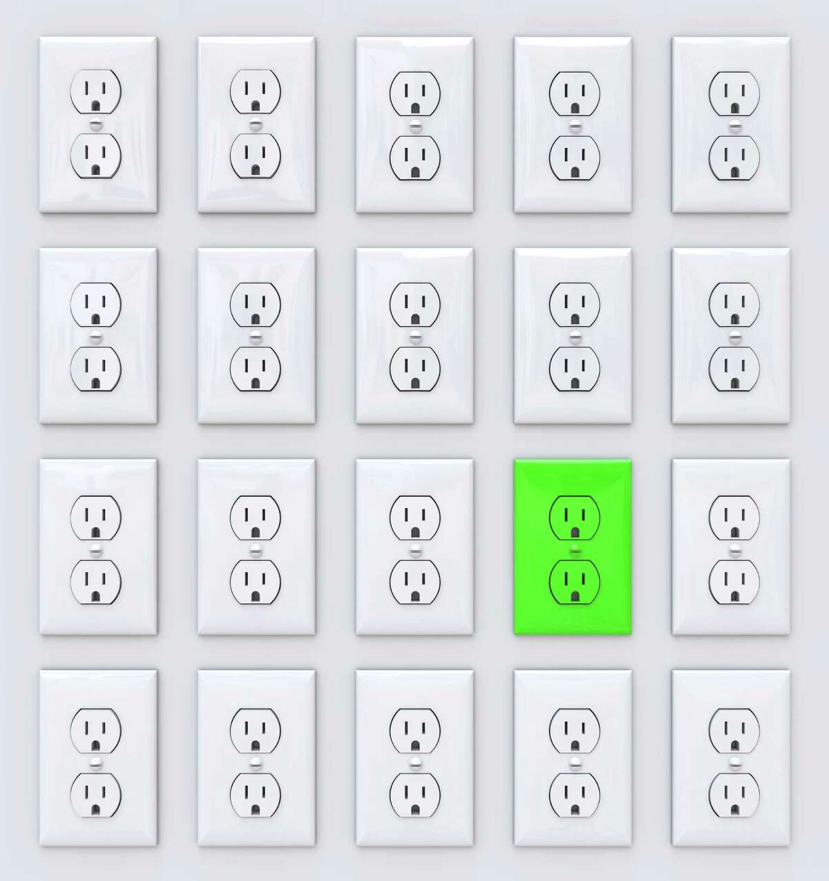 A green power outlet stands apart from many white ones