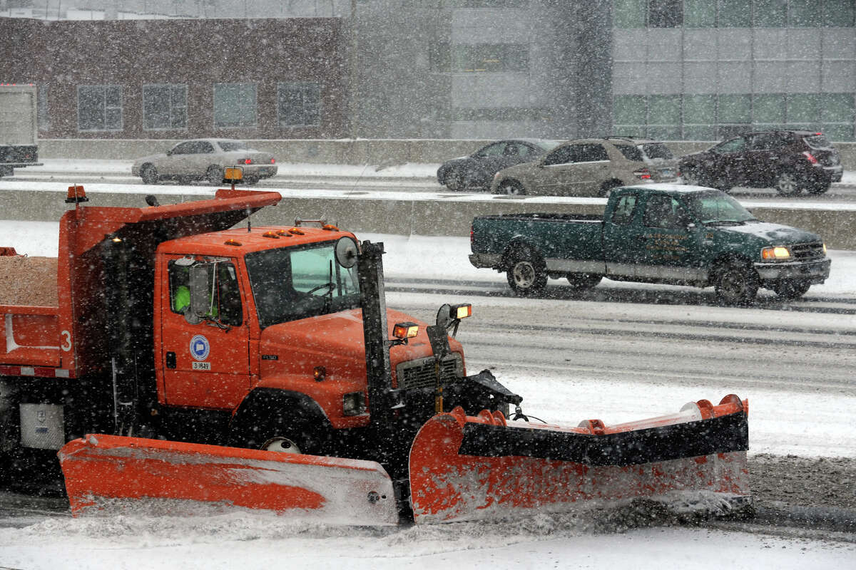 A state Department of Transportation truck plows snow along I-95 in Bridgeport during a storm in January. This winter is the first season the DOT has used a magnesium chloride slurry on highways in advance of storms. Truckers say the corrosive mixture is causing undercarriage and brake line corrosion .
