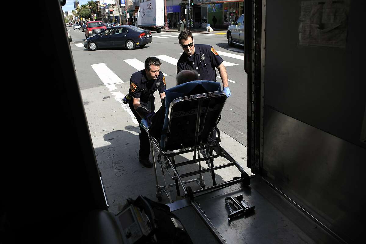 EMT Alex Lamond, right, and Paramedic Josh Smith wheel a diabetic patient, who called for help because he was feeling weak and dizzy, into their waiting ambulance, in San Francisco, CA Saturday, March 1, 2014.