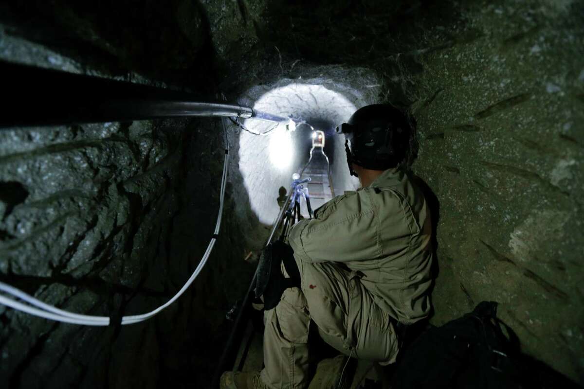In photo taken on Nov. 4, 2013, a Homeland Security Investigations member of the special response team looks south in a border tunnel equipped with lighting, ventilation and an electric rail system discovered between Tijuana, Mexico and San Diego in San Diego. Discovered on Oct. 30, 2013, the secret passage on the U.S.-Mexico border was linked by authorities to Mexico's Sinaloa cartel and its leader, Joaquin "El Chapo" Guzman, who was arrested on Feb. 22, 2014 in Maztalan, Mexico. (AP Photo/Gregory Bull)