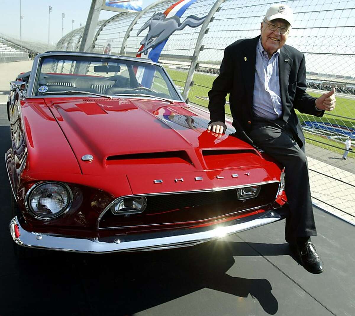 This April 15, 2004 file photo shows Carroll Shelby sitting on a 1968 GT500 KR during the celebration of the 40th Anniversary of the Ford Mustang at the Nashville Super Speedway in Lebanon, Tennessee. Shelby, the greatest single influence on America's racing posture in the post-1945 period with help in the engine design and racing operations of the Mustang, died May 10, 2012 at the age of 89.