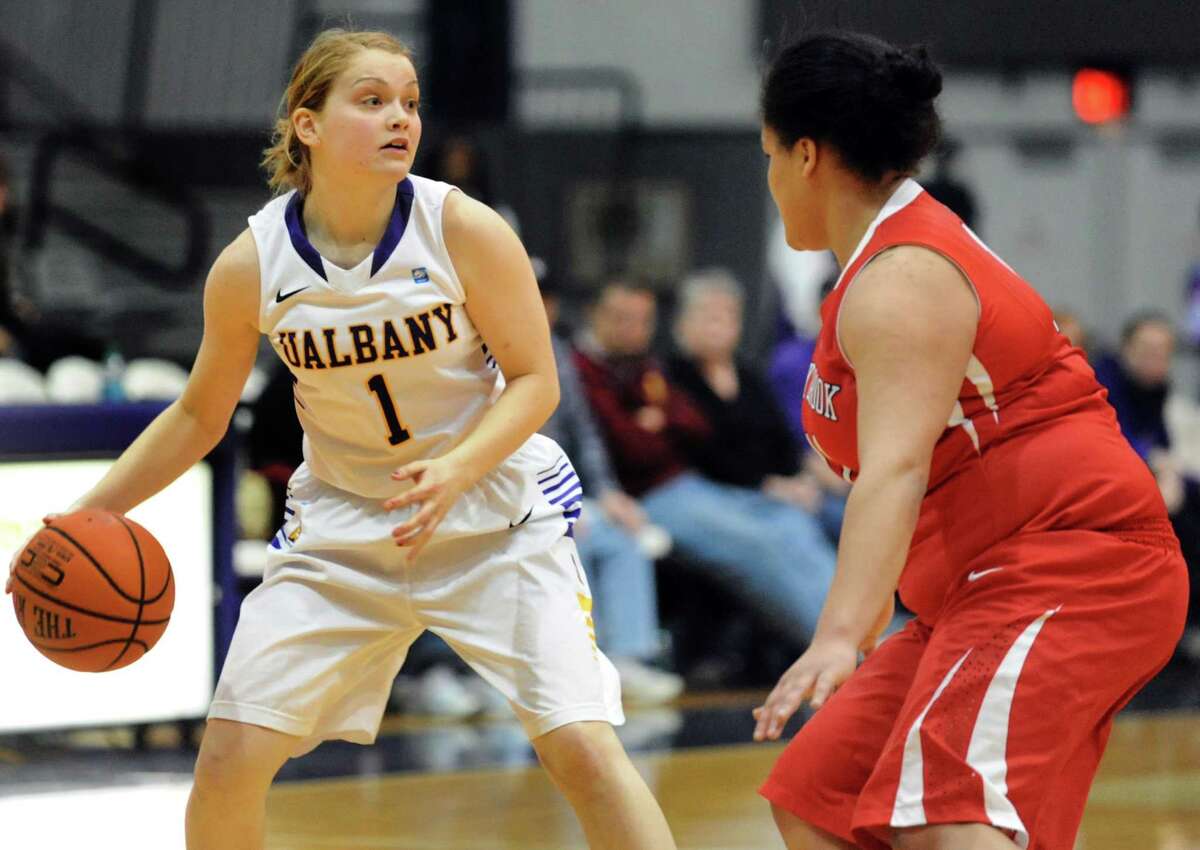UAlbany's Erin Coughlin, left, looks to pass as Stony Brook's Kori Bayne-Walker defends during their basketball game on Saturday, March 1, 2014, at UAlbany in Albany, N.Y. (Cindy Schultz / Times Union)