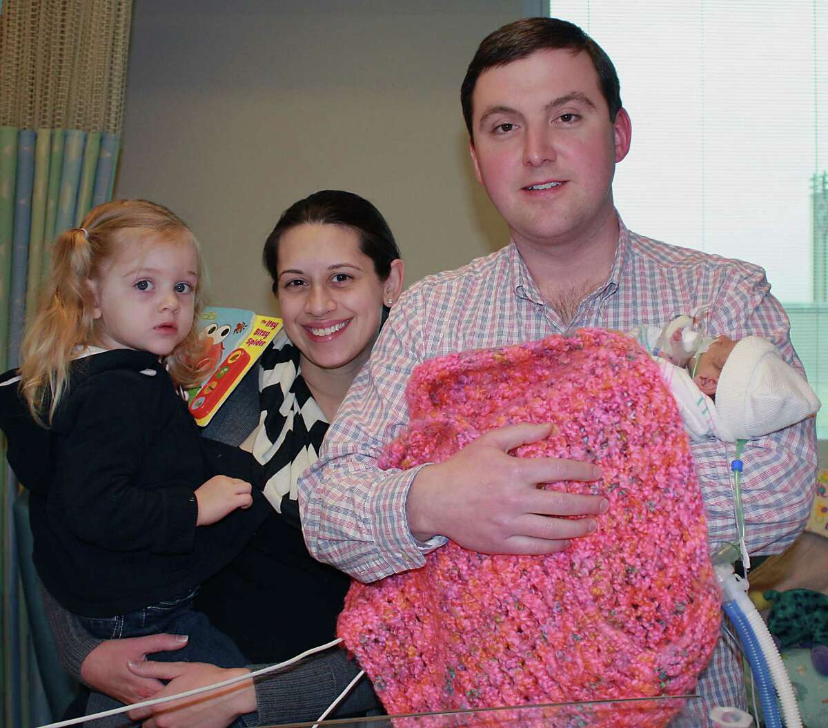 A photograph of Farah and Patrick Armstrong with their daughter Sophie Armstrong left, and Madeline Leigh Armstrong, Madeline was born and later she died of CMV, a rare disease that can cause serious complications and even death in babies infected before birth Thursday, Feb. 27, 2014, in Katy. Armstrong Family Photograph