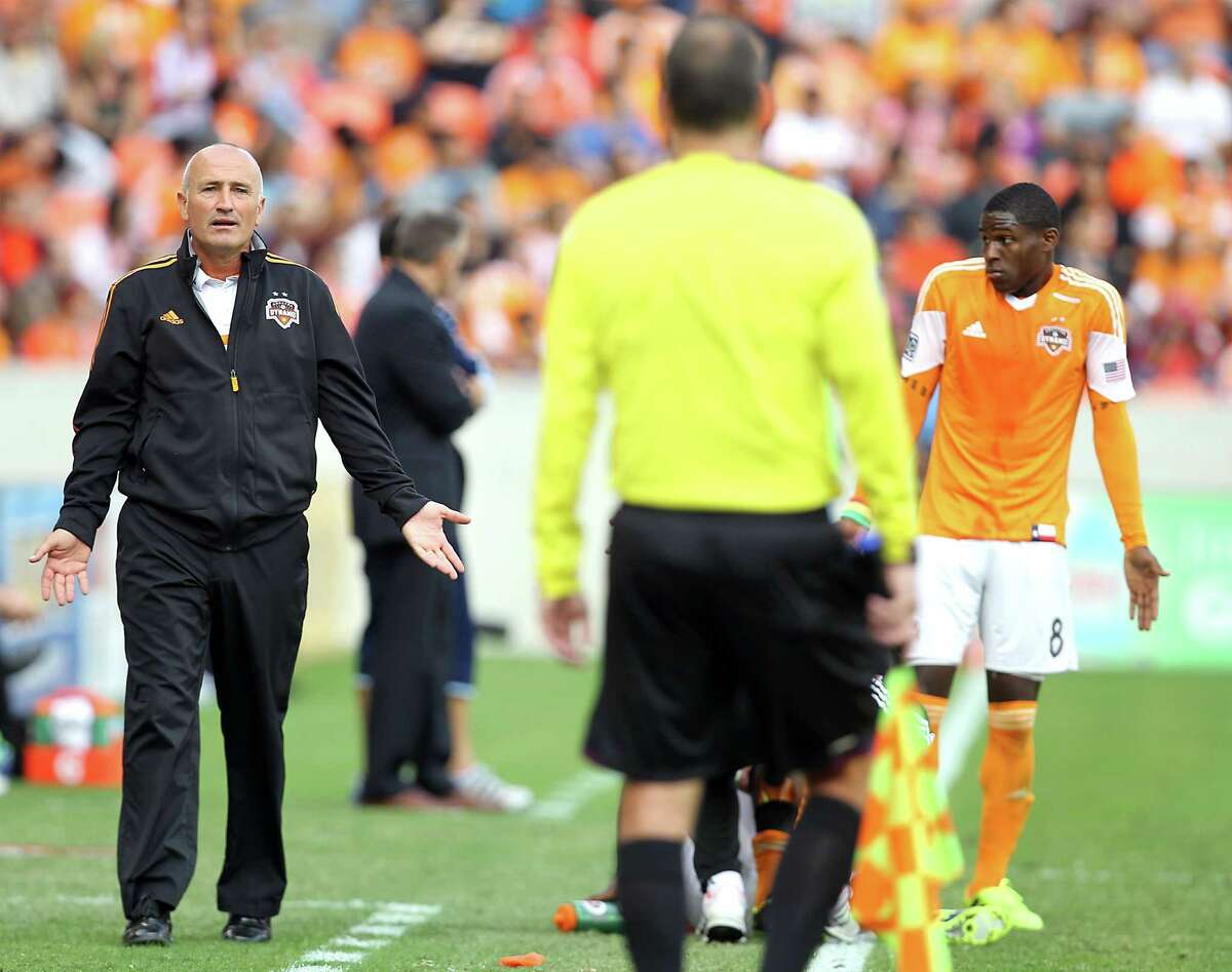 Houston Dynamo head coach Dominic Kinnear left, call out to an official as Houston Dynamo defender Kofi Sarkodie right, looks on during the second half of the MLS Eastern Conference Final game against the Sporting KC at BBVA Compass Stadium Saturday, Nov. 9, 2013, in Houston. ( James Nielsen / Houston Chronicle )