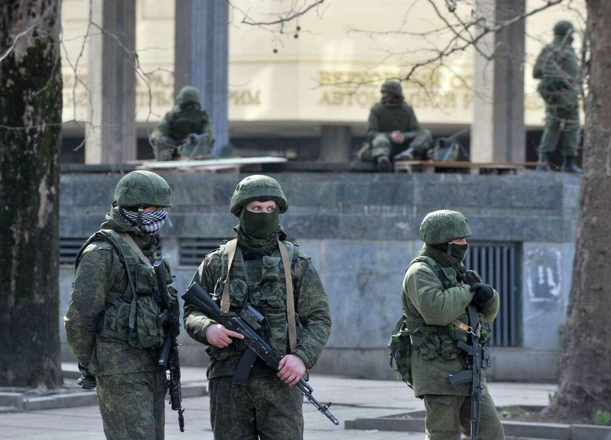 Armed men patrol outside the Crimean Parliament on Saturday in Simferopol, where pro-Russian forces tightened their grip as the Kremlin vowed to help restore calm on the restive Ukrainian peninsula. Dozens of men in full combat gear were patrolling Simferopol in the Ukrainian territory, where the majority of the population is Russian and where one of Moscow's main fleets is based.