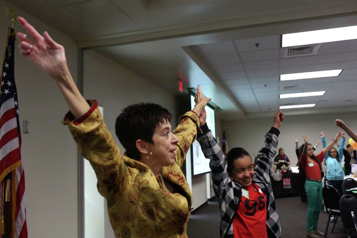 Tracy Tylman teaches “power posing” with the help of participant Jeanette Ramirez, 12, during the Women's Global Connection Girls' Global Summit at the University of the Incarnate Word Rosenberg School of Optometry.