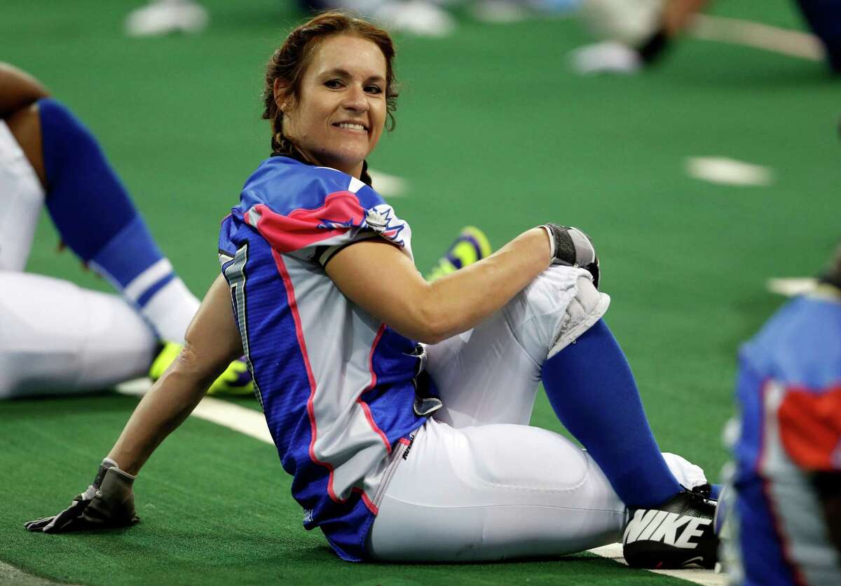 Texas Revolution's Jennifer Welter warms up for the Revolution's Indoor Football League game against the North Texas Crunch on Saturday, Feb. 15, 2014, in Allen, Texas. Welter became what is believed to be the first woman who wasn't a kicker or holder to play in a men's pro football game. The 5-foot-2, 130-pound resident of North Texas was thrown for a 1-yard loss on her first carry as a running back. (AP Photo/The Dallas Morning News, Vernon Bryant) MANDATORY CREDIT; MAGS OUT; TV OUT; INTERNET USE BY AP MEMBERS ONLY; NO SALES