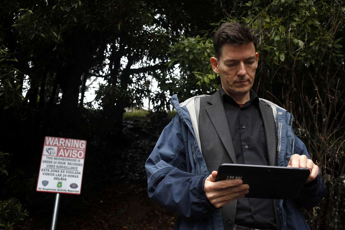 Jesper Jurcenoks shows how he can use an iPad to check the residential surveillance system that he and his neighbors installed to stop burglaries on Friday February 28, 2014, in Oakland, Calif. Instead of just the home security systems some neighborhoods have gotten more serious and have installed network of linked cameras that can help to protect the entire blocks.
