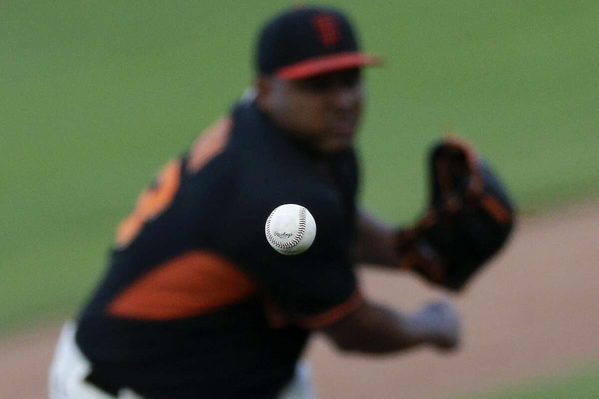 San Francisco Giants relief pitcher Jean Machi watches his pitch to an Arizona Diamondbacks batter during the ninth inning of a spring training baseball game Sunday, March 2, 2014, in Scottsdale, Ariz. (AP Photo/Gregory Bull)