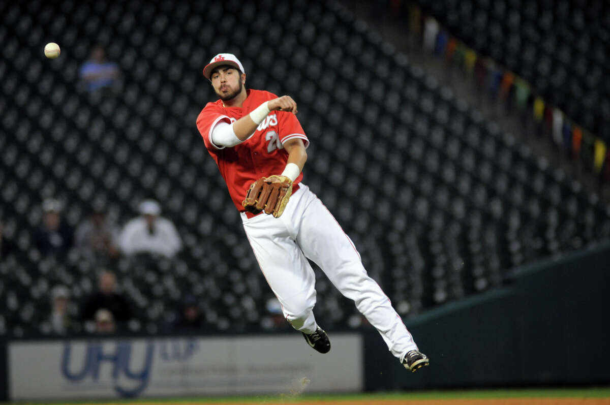 UH third baseman Justin Montemayor makes an acrobatic play to retire TCU's Kyle Bacak.