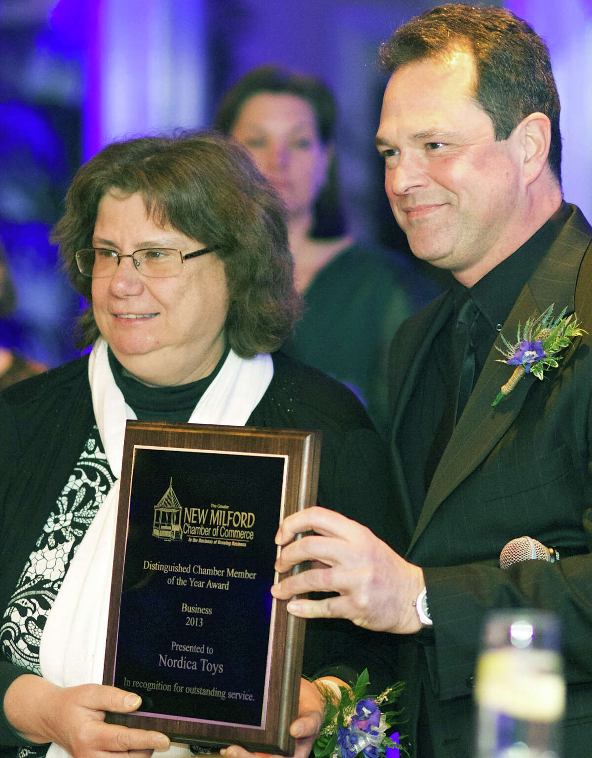 Marie McCarthy of Nordica Toys proudly accepts the Greater New Milford Chamber of Commerce's