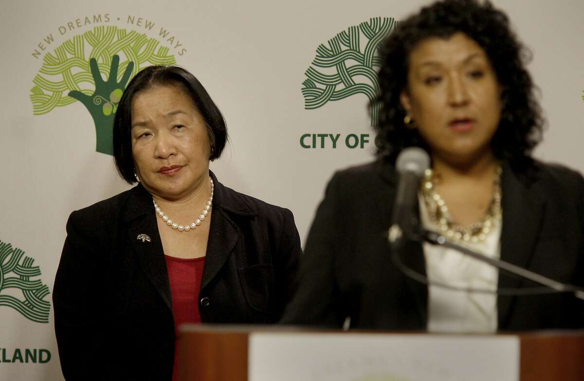Mayor Quan (left) listened as City Administrator Deanna J. Santana explained the numbers. Oakland officials including Mayor Jean Quan presented an amended policy budget to balance the city budget following the loss of Redevelopment funding Monday January 23, 2012.