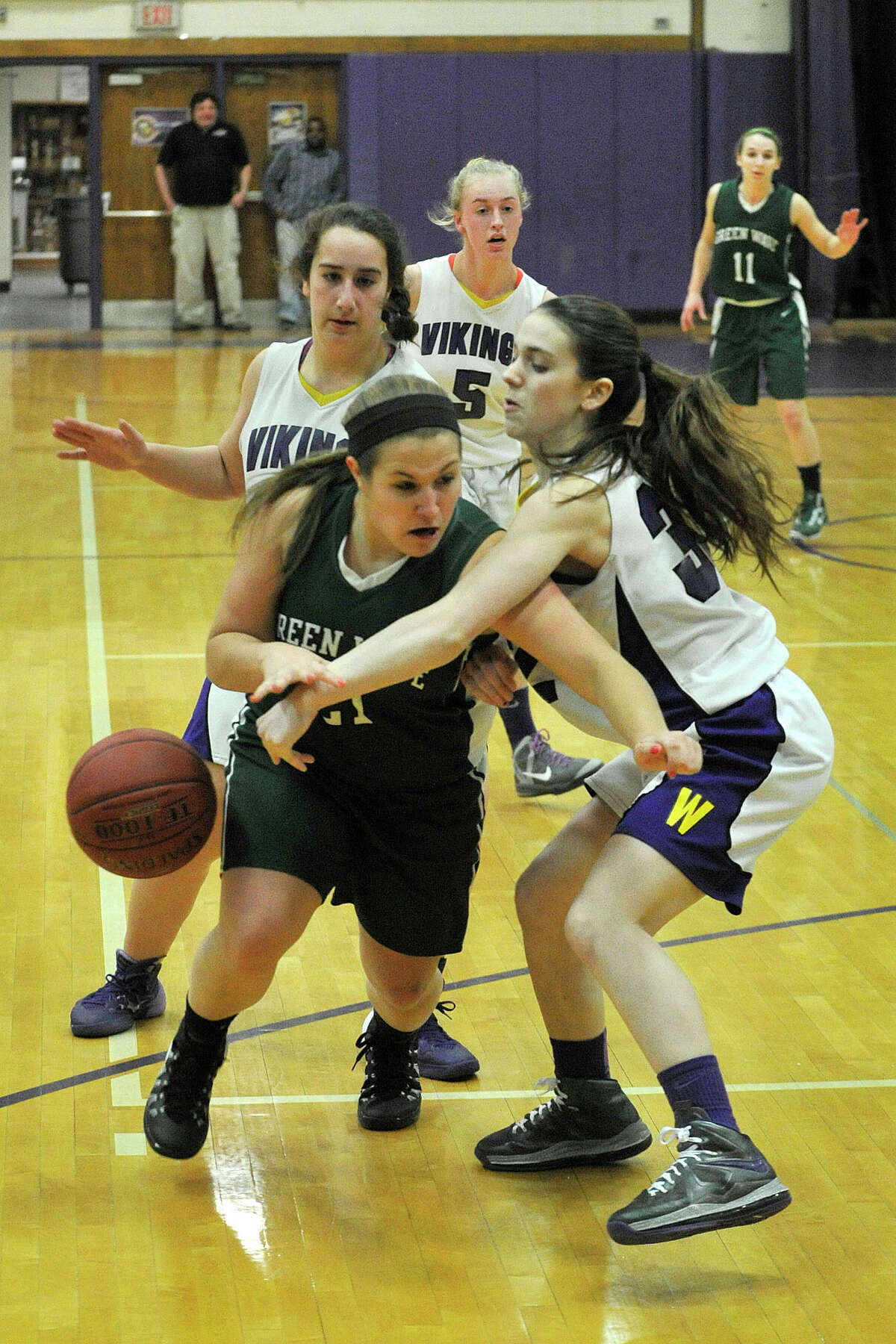 Westhill's Elizabeth Grosso smacks the ball from the hands of Lindsey Heaton, of New Milford, during their Class LL basketball game at Westhill High School in Stamford, Conn., on Monday, March 3, 2014. Westhill won, 40-30.