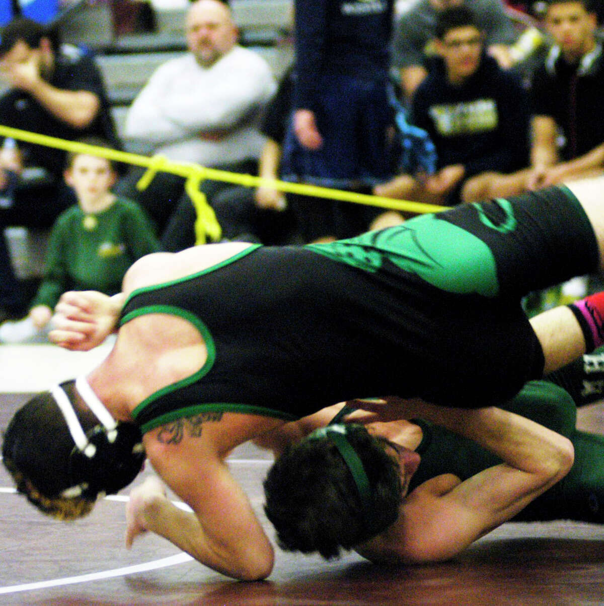 Green Wave senior Halim Bourjeli, top, duels Ryan Pantalena of Maloney in the 106-pound semifinals for New Milford High School wrestling in the state class 'L' tournament at Bristol Central High School, Feb. 22, 2014.