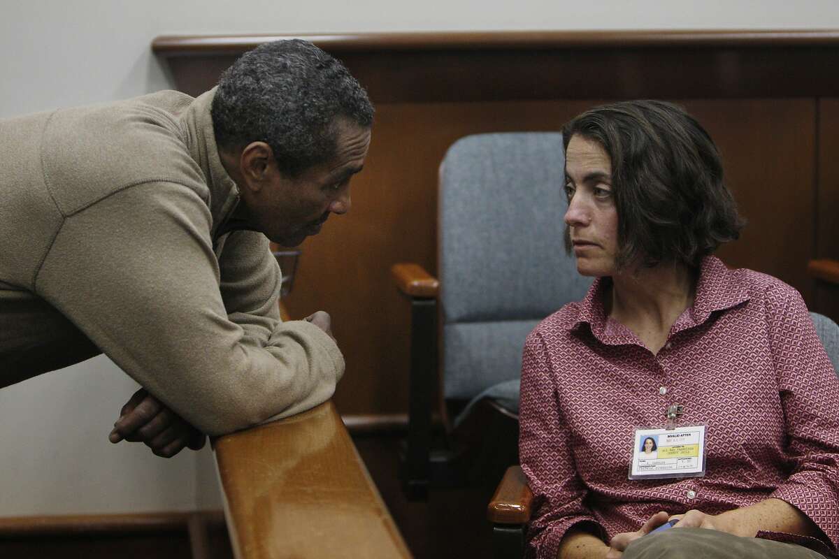Chesterfield Jones (l to r) talks with Robin Candler, program manager for court accountable homeless services, who was working with Jones on his treatment plan in the Community Justice Center courtroom on Monday, March 3, 2014, in San Francisco, Calif.
