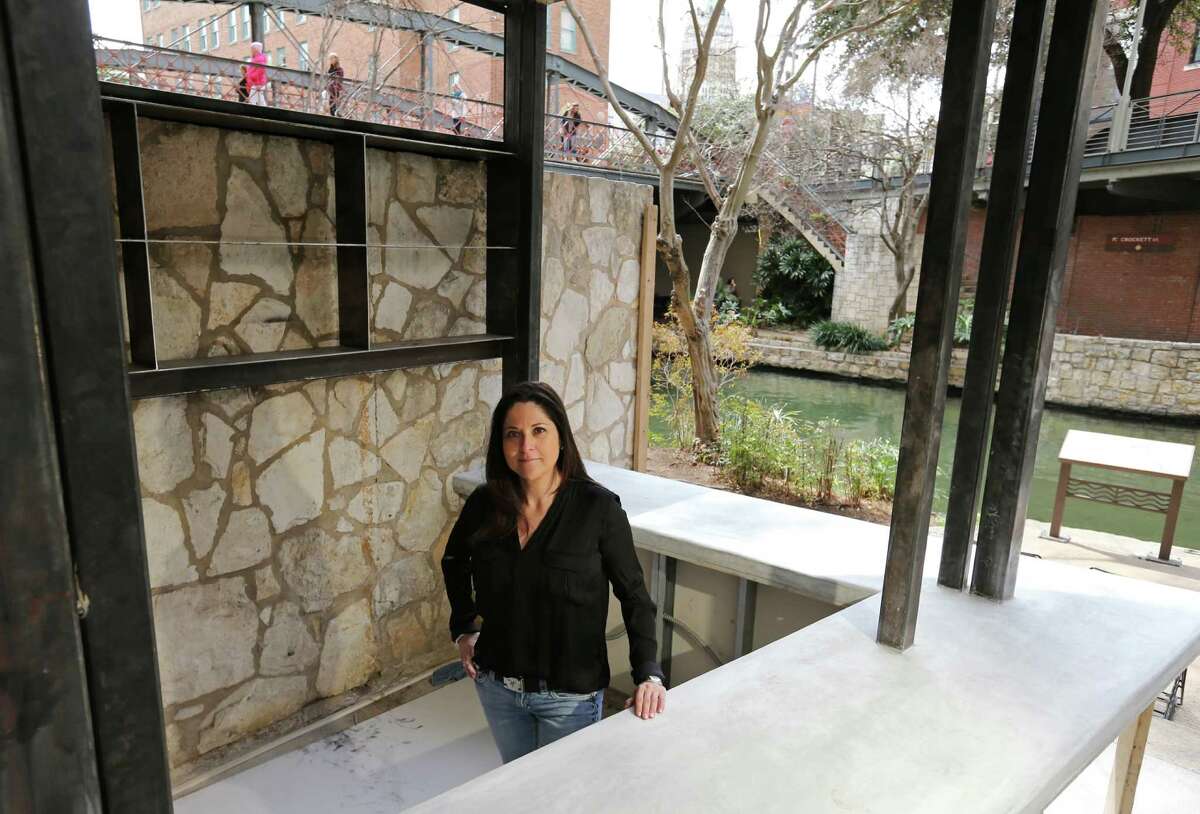 Portrait of Lori Urbano, owner of Urbano Design & Build, with the bar she designed that is under construction Monday March 3, 2014 at The Worm Tequila & Mezcal Bar.