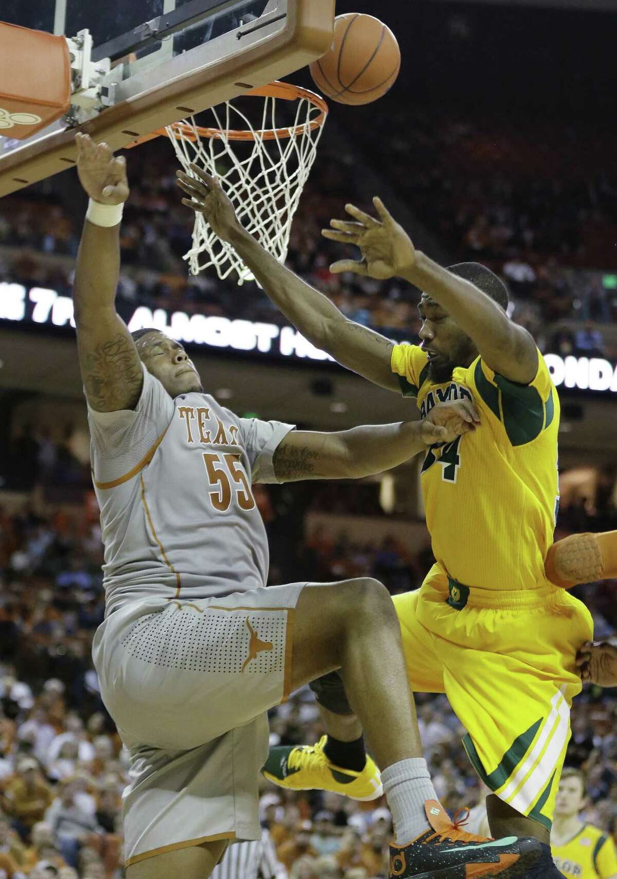 Texas' Cameron Ridley (55) blocks Baylor's Cory Jefferson (34) during the second half of an NCAA college basketball game, Wednesday, Feb. 26, 2014, in Austin, Texas. Texas won 74-69. (AP Photo/Eric Gay)