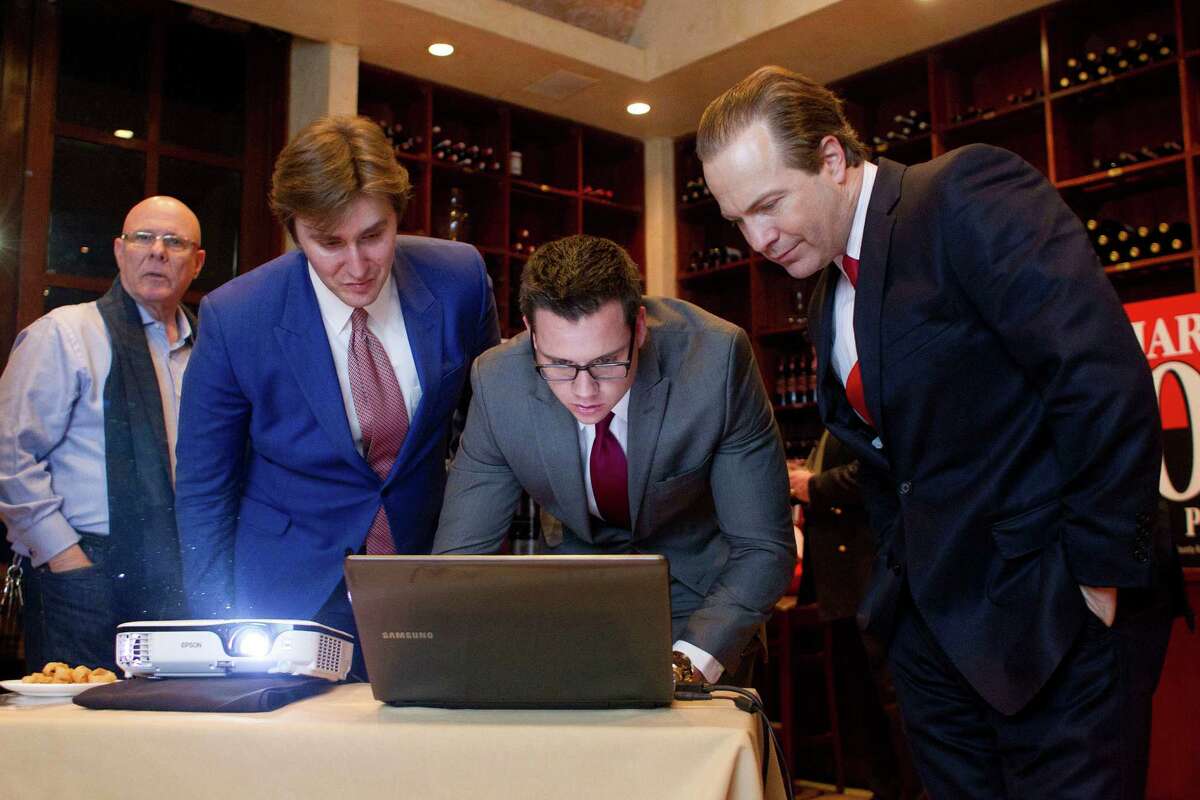 From left, Mark Lipkin, John Griffing, Jonathan Nessmith and incumbent Harris County Republican Party Chairman Jared Woodfill look at voting numbers.