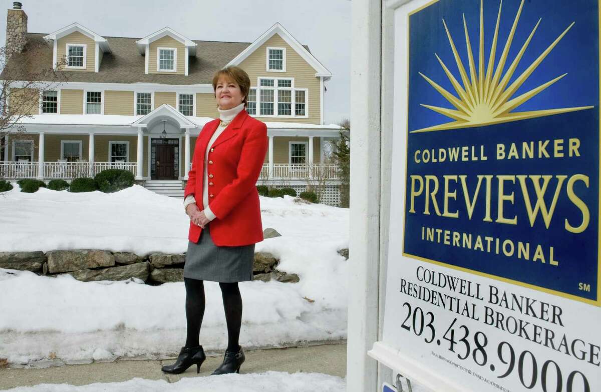 Cathleen Smith, president of Ridgefield-based Coldwell Banker, in front of a house her firm is representing in Ridgefield, Conn. on Wednesday, March 5, 2014.