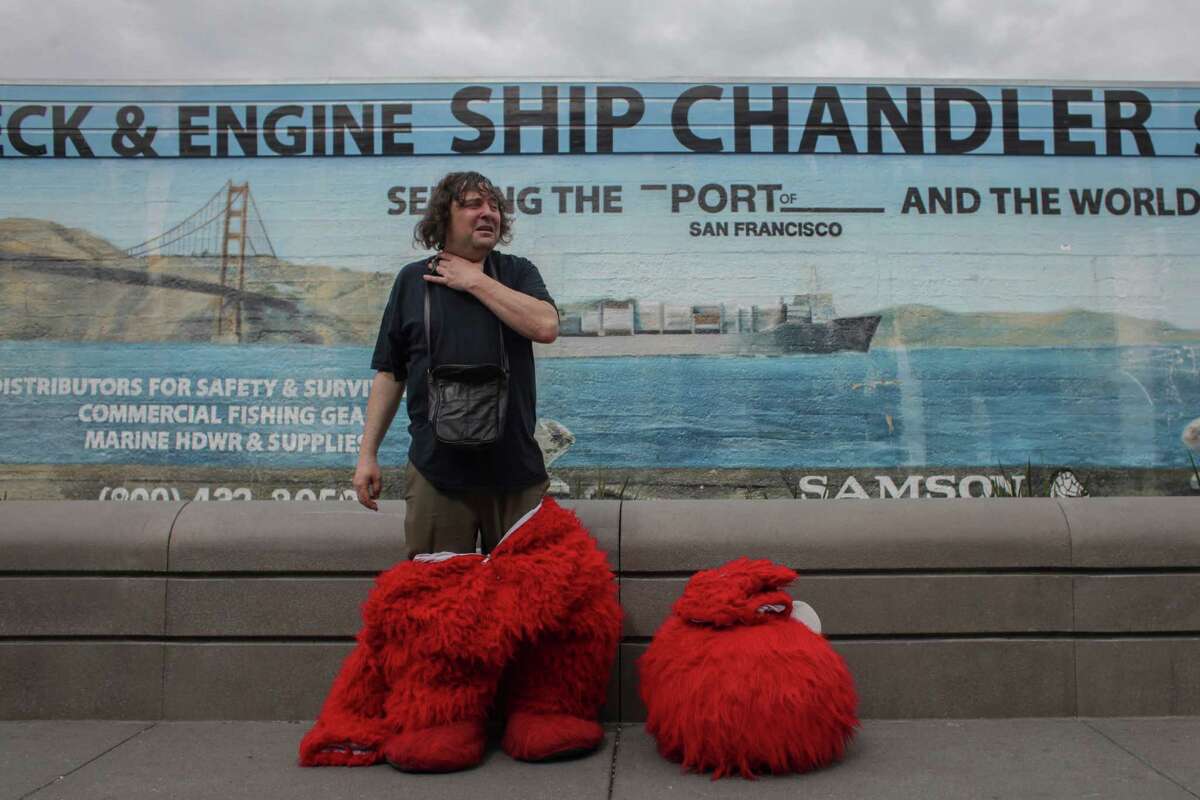 Dan Sandler takes a break from posing for photos with tourist dressed as Elmo in Fisherman's Wharf on March 5th 2014. Sandlers has been known to go on various heated controversial rants while wearing the costume.