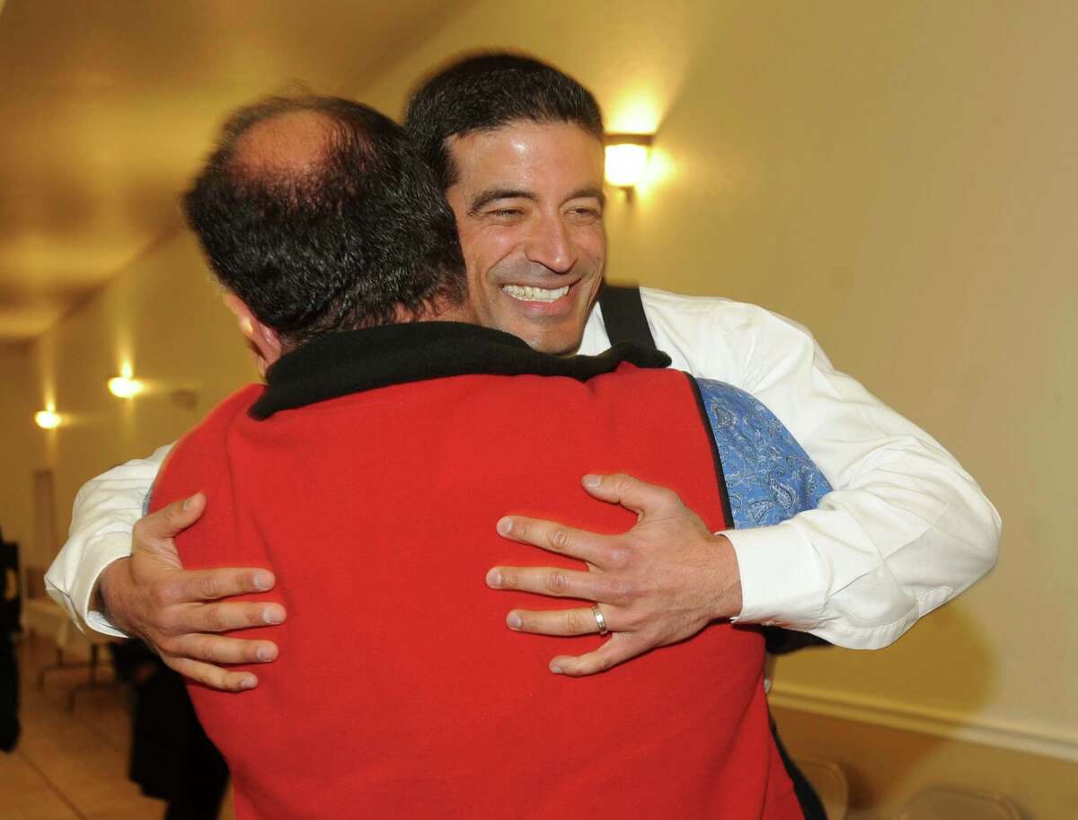 Nicholas LaHood, who is running in the Democratic primary for district attorney nomination, is greeted by friend Art Silva at San Antonio Professional Firefighters Banquet Hall on election night, Tuesday, March 4, 2014.