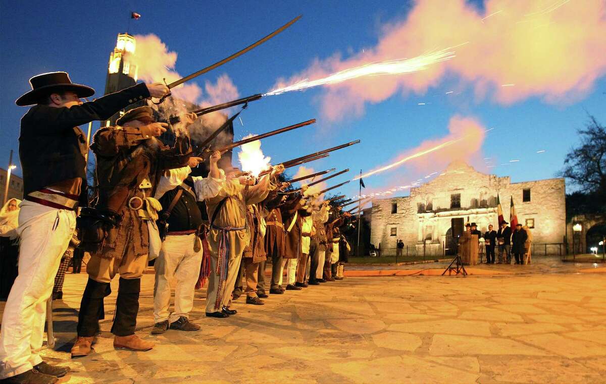 Members of the San Antonio Living History Association fire muskets on Thursday, March 6, 2014 in front of the Alamo during the "Dawn at the Alamo" ceremony on the 178th anniversary of the battle for Texas independence. Hundreds of people gathered in the cold pre-dawn hours to witness the solemn remembrance that included a performance by a youth choir and a wreath laying ceremony.