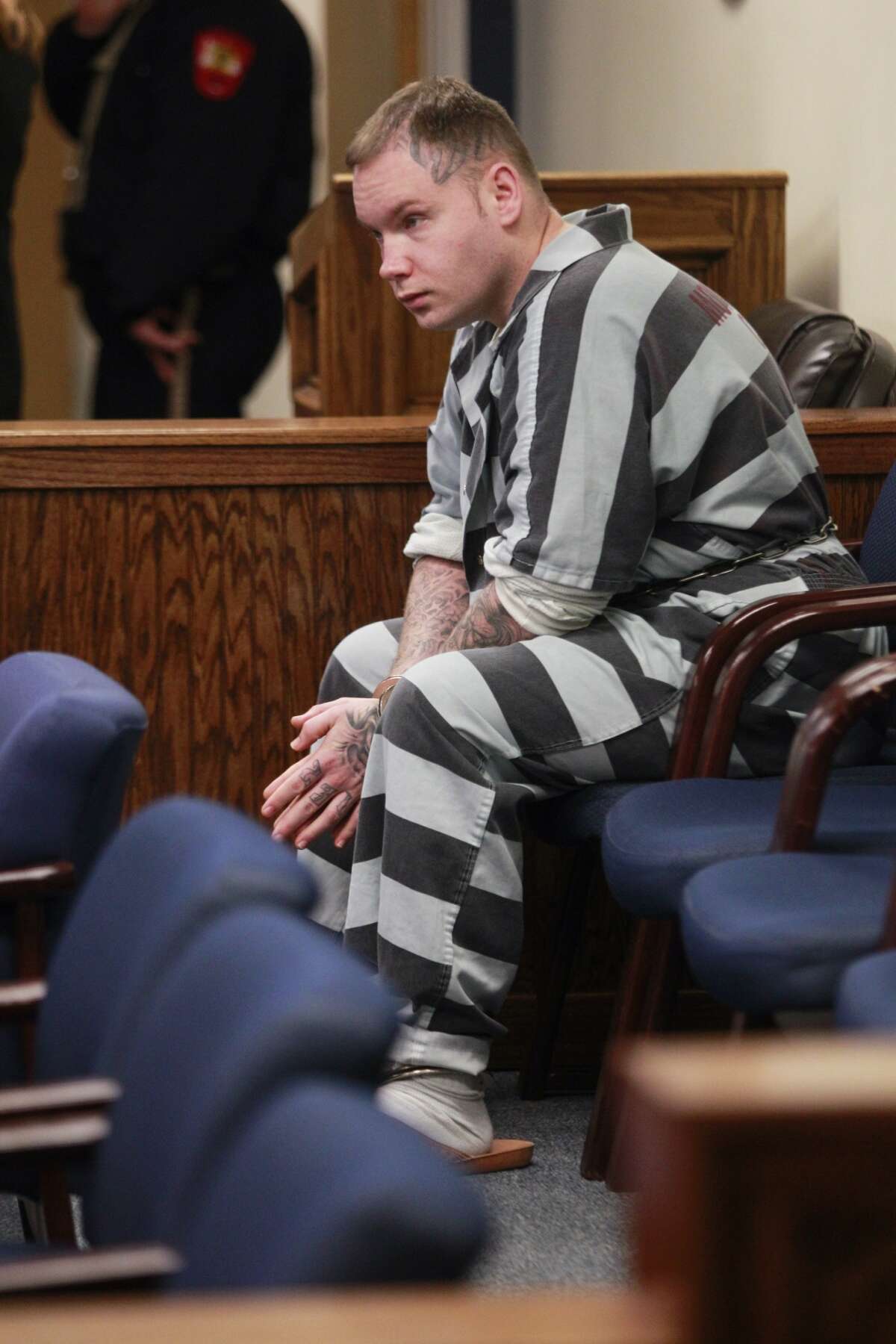 Donald Collins sits in the 359th State District Court on Thursday, March 6, 2014, in Conroe waiting to be transported after Judge Kathleen Hamilton ruled that he will be tried as an adult for allegedly setting 8-year-old Robert Middleton on fire with gasoline in 1998. Robert died in 2011.