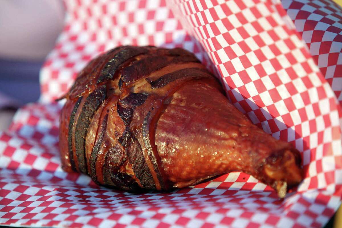 New food stand named "Get Pickled" sells bacon wrapped turkey legs in the Midway of the Houston Livestock Show and Rodeo on Feb. 27, 2014.