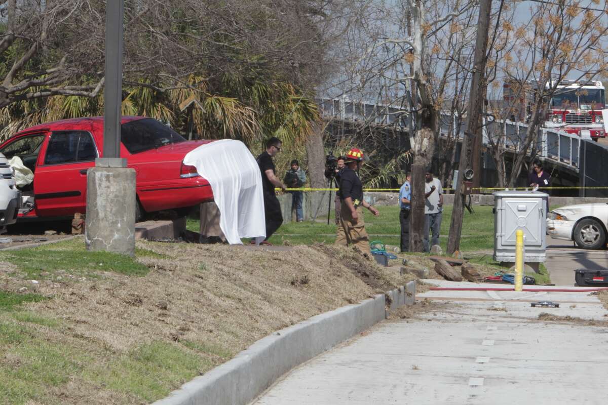 Officials investigate the scene of a fatal traffic accident, March 6, 2014. (James Nielsen / Houston Chronicle)