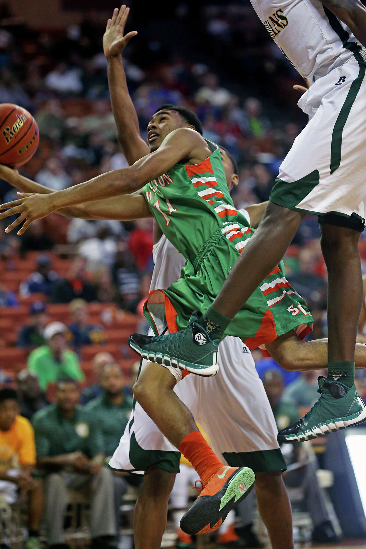 Jawon Anderson tries an off balance runner against heavy pressure as Sam Houston plays Dallas Madison at the Erwin Center in Austin in the state semifinals for 3A basketball on March 6, 2014.