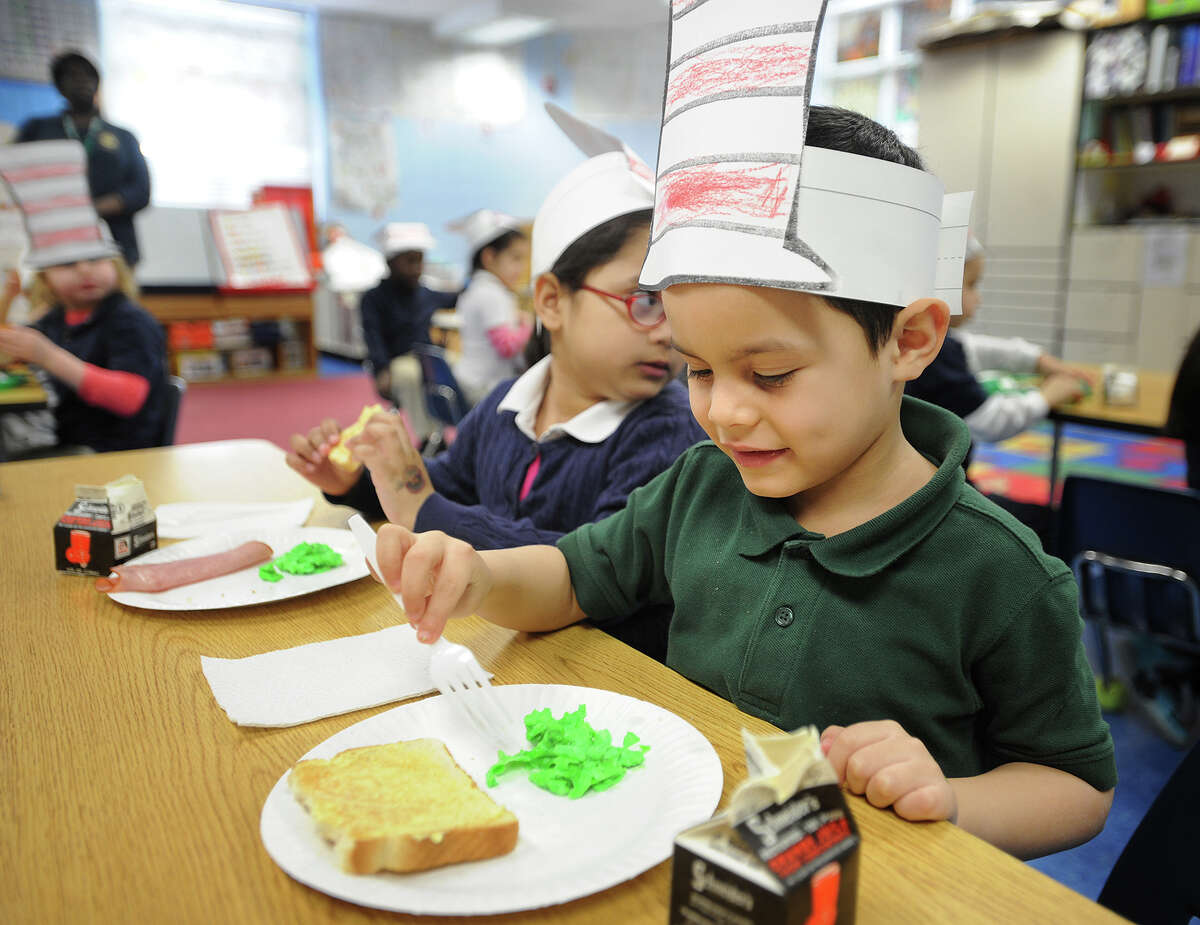 Alex Rodriguez, 5, tries green eggs and ham in his dual language kindergarten class at Luis Munoz Marin School in Bridgeport, Conn. on Wednesday, March 5, 2014.