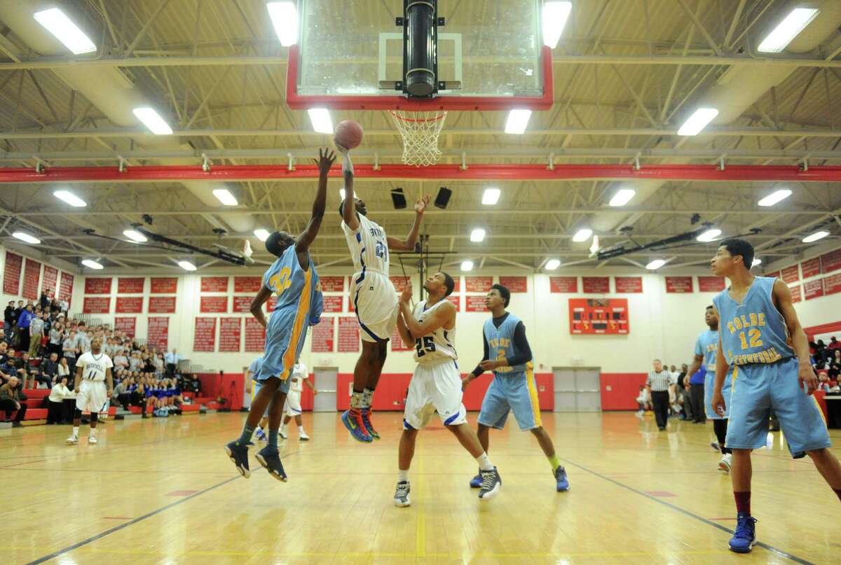 Bunnell's Issac Vann (23) tips in a basket past Kolbe Cathedral defender Ian Gardener (32) in the SWC boys basketball championship game between No. 2 Bunnell and No. 5 Kolbe Cathedral at Pomperaug High School in Southbury, Conn. Thursday, March 6, 2014.