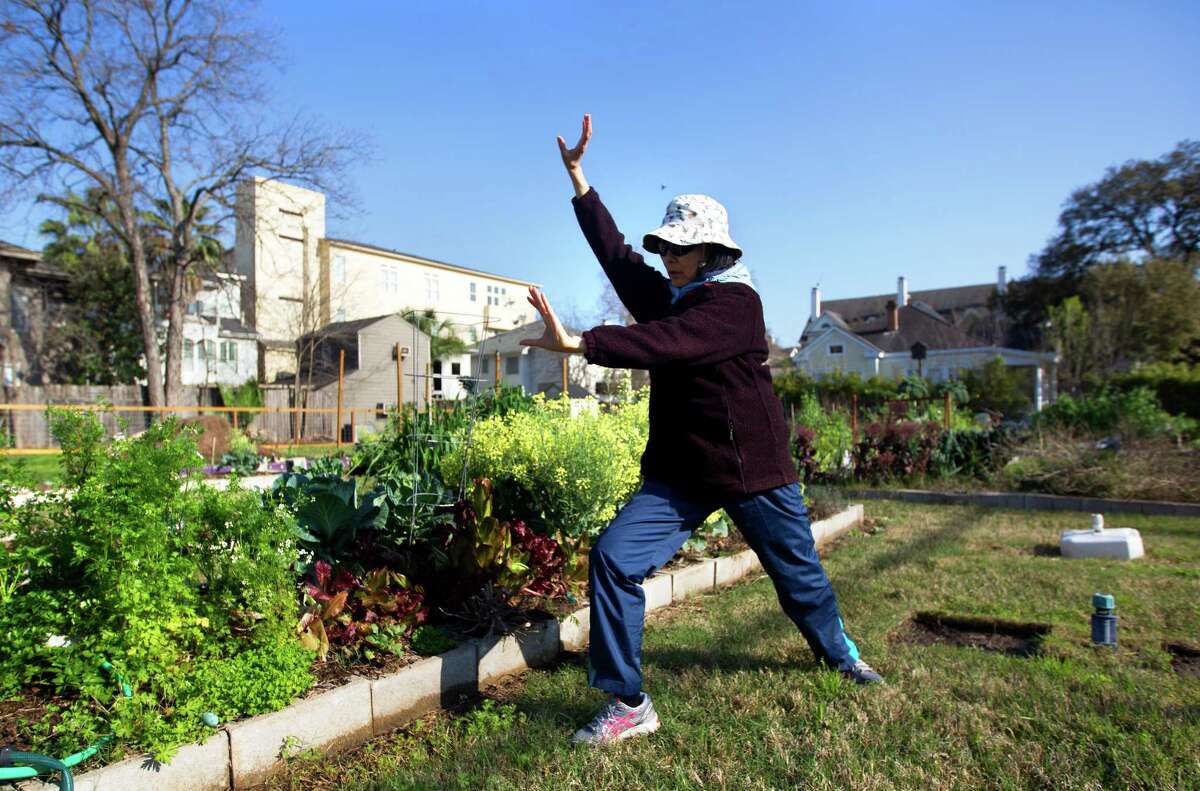 Liping Gong practices tai chi Thursday in the Midtown Community Garden, which has been sold to a developer.