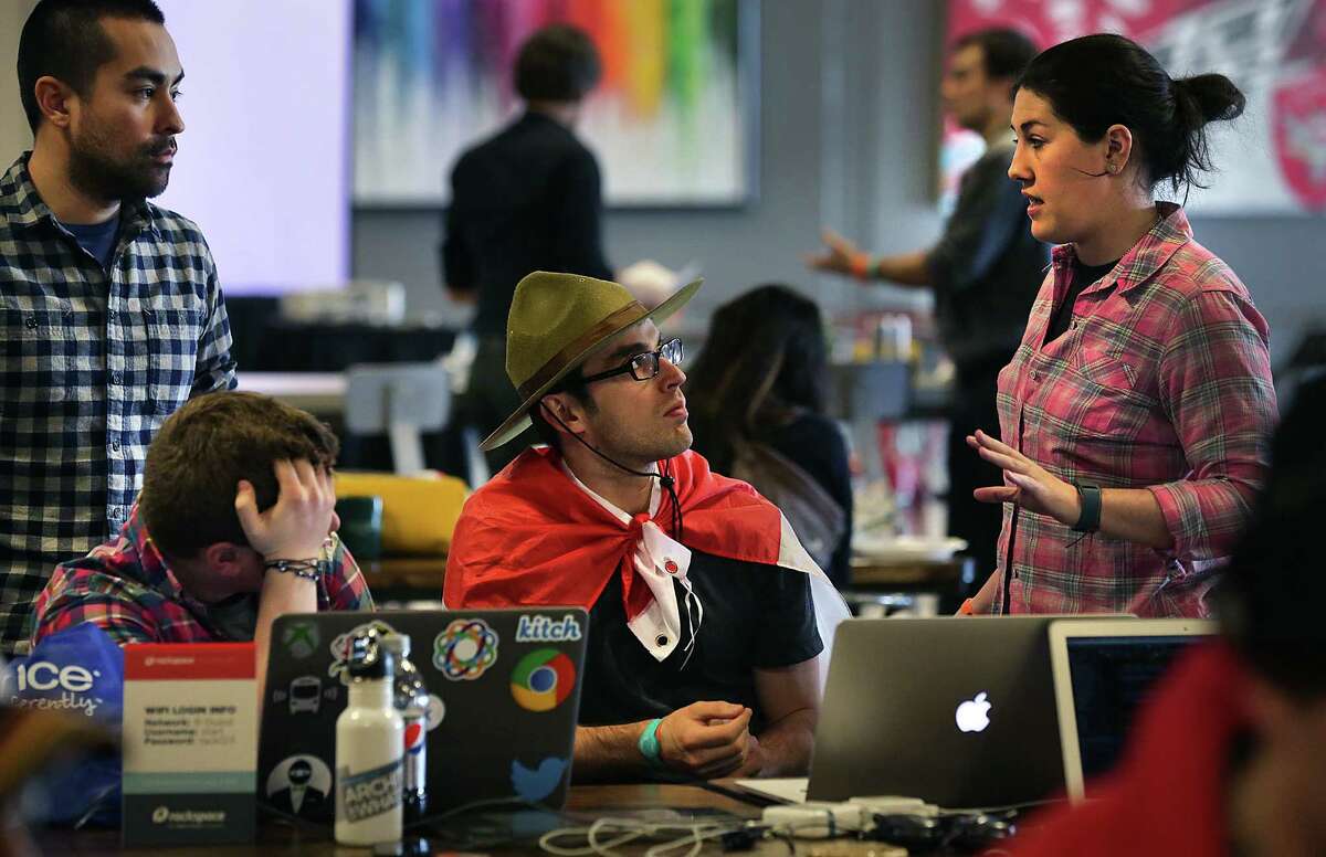 Rachel Blackman (right) of New York, gives pointers to Paul Vlahov (center) and Cesar Kuriyama (far left) as they prepare for the finals competition.