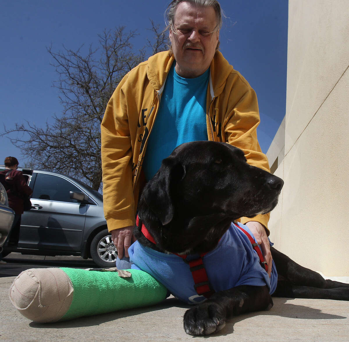 Ronald Zawacki-Maldonado pets Debbie outside South Texas Veterinary Specialists in San Antonio. The formerly stray dog then headed home to Zawacki-Maldonado's place in Eagle Pass, where she was hit by a car and injured in January.