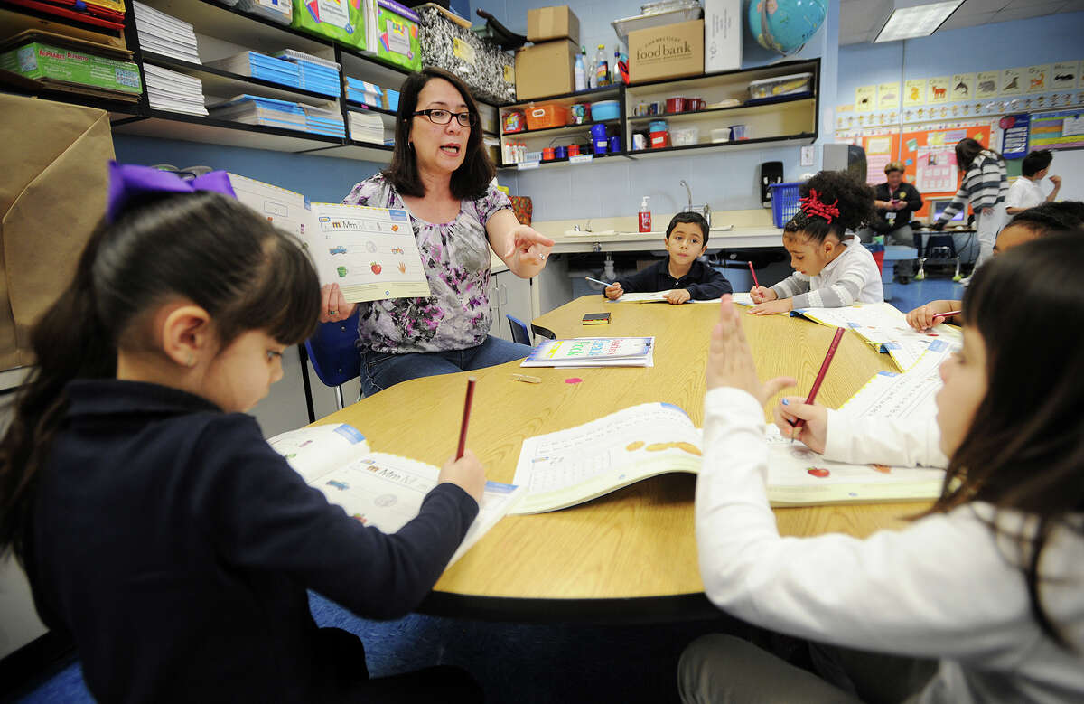 Evelyn Barrios works with her students in her dual language kindergarten class at Luis Munoz Marin School in Bridgeport, Conn. on Wednesday, March 5, 2014.