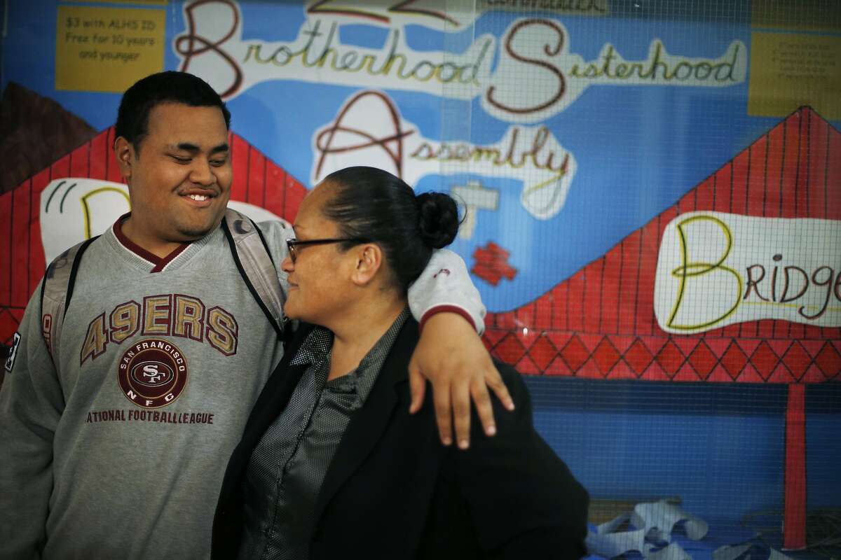 Robert hugs his mom, Maggie Winterstein, in the hallway at Lincoln High School in San Francisco, Calif., on Tuesday, March 4, 2014. Through the Legal Education Advocacy Project, the San Francisco Public Defender's office provides legal help for students navigating educational needs after they've dealt with criminal charges. These lawyers help students receive the support they need to get back in school as well as counseling and proper placement in classes that will benefit them the most.