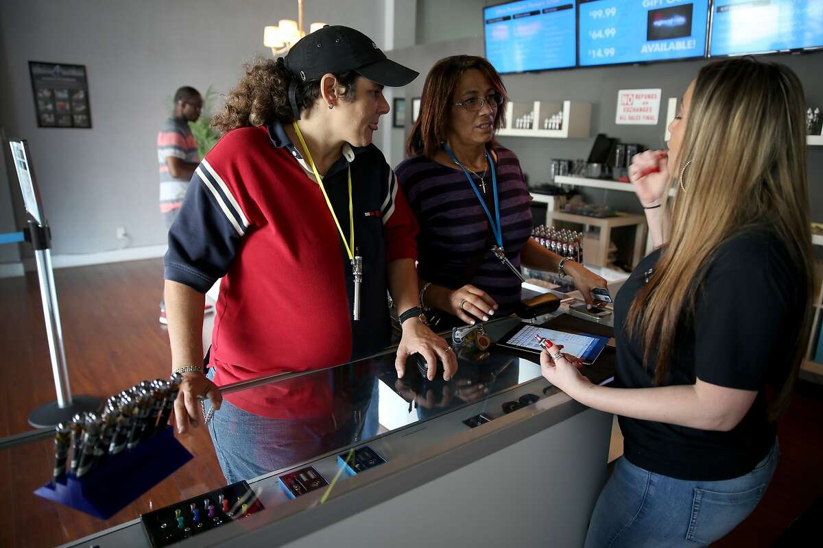 MIAMI, FL - FEBRUARY 20: Brenda Calana (L) and Teresa Hernandez speak with sales associate, Maylynn Moreno, as they shop for an electronic cigarette at the Vapor Shark store on February 20, 2014 in Miami, Florida. As the popularity of E- cigarettes continue to grow, leading U.S. tobacco companies such as Altria Group Inc. the maker of Marlboro cigarettes are annoucing plans to launch their own e-cigarettes as they start to pose a small but growing competitive threat to traditional smokes. (Photo by Joe Raedle/Getty Images)