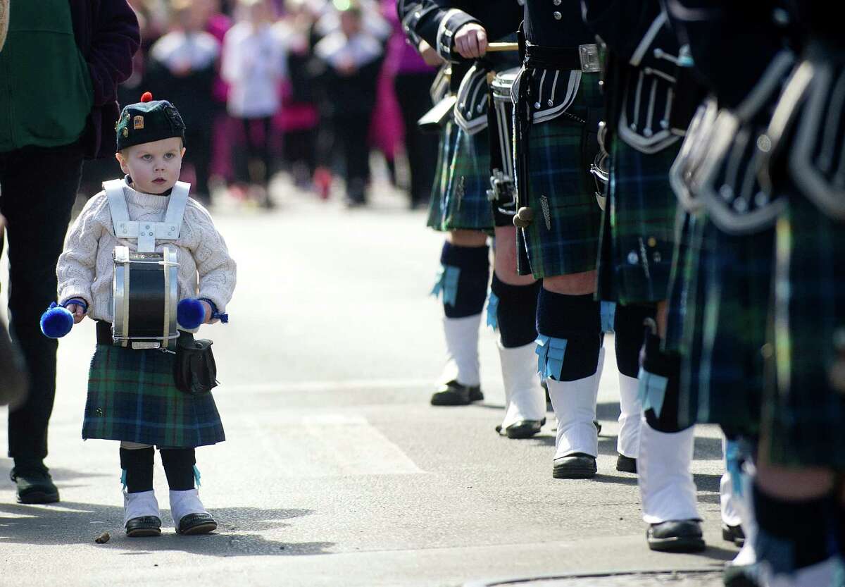 A young boy marches alongside a pipe band in the 19th annual St. Patrick's Day parade in Stamford, Conn., on Saturday, March 8, 2014.
