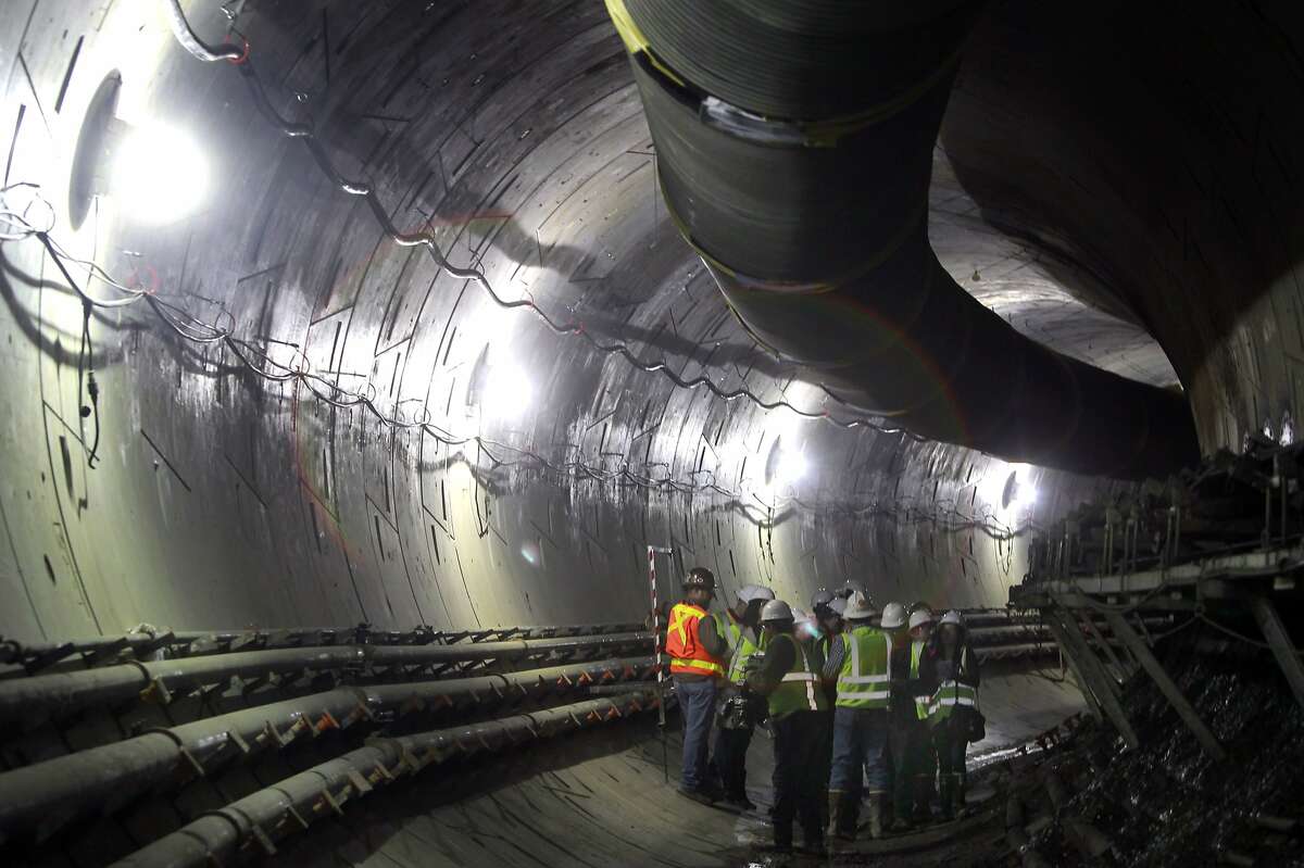 Visitors are updated on construction inside the northbound tunnel of Muni's Central Subway in San Francisco, Calif. on Saturday, March 8, 2014. Two large boring machines, Big Alma and Mom Chung, are grinding their way north from Fourth and Bryant streets towards Chinatown and North Beach.